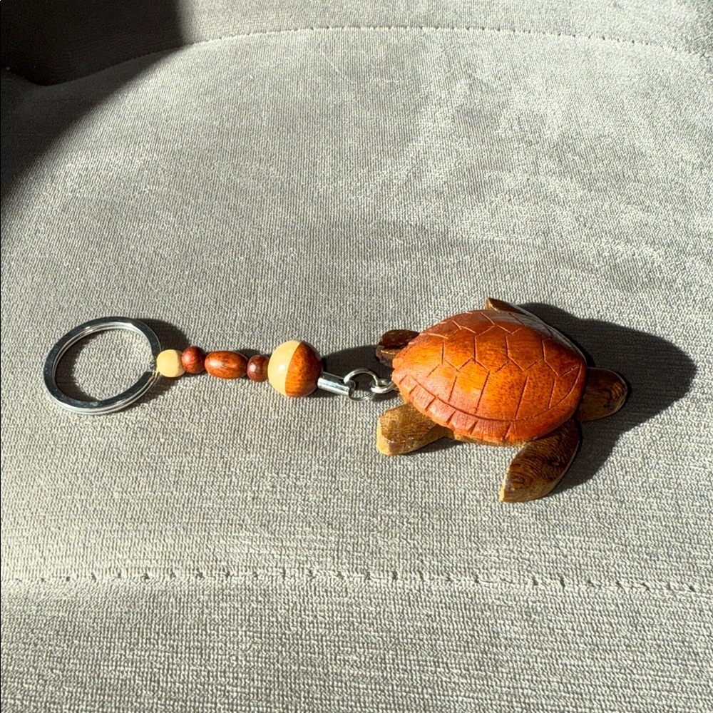 Free w/ $25 purchase. Ron Jon surf shop wooden turtle key chain. Bundle to save